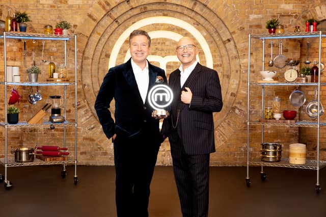 John Torrode and Gregg Wallace in the MasterChef kitchen, holding the MasterChef trophy (Credit: BBC/Shine UK)
