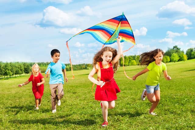 Children flying a kite (photo: adobe)
