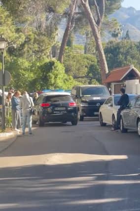 A police car patrols the street outside the Marbella Airbnb on April 25.