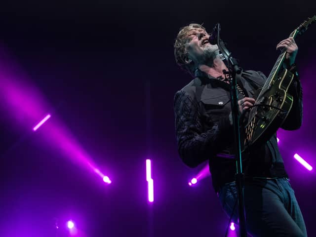 Josh Homme performing at Roskilde Festival 2023. Queens of the Stone Age are set to headline Friday night at Download Festival 2024 - but what could they play and what merchandise could be for sale at the festival? (Credit: Getty Images)