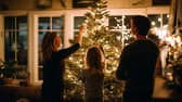 A family gathers to decorate the Christmas tree, a moment that often sparks conversations about traditions, relatives and family history passed down through generations.