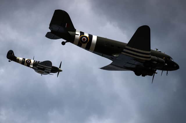 A Douglass C-47 Dakota (R) and a Sptifire fly over Arromanches-les-Bains, northwestern France, on 6 June 6 2019 as part of D-Day commemorations marking the 75th anniversary of the World War II Allied landings in Normandy.