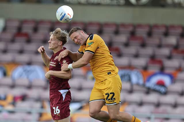 Sam Chambers goes up for a header