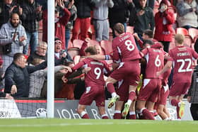 Jon Guthrie and his team-mates celebrate with the away fans at Blundell Park 