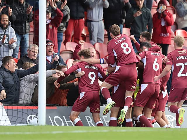 Jon Guthrie and his team-mates celebrate with the away fans at Blundell Park 