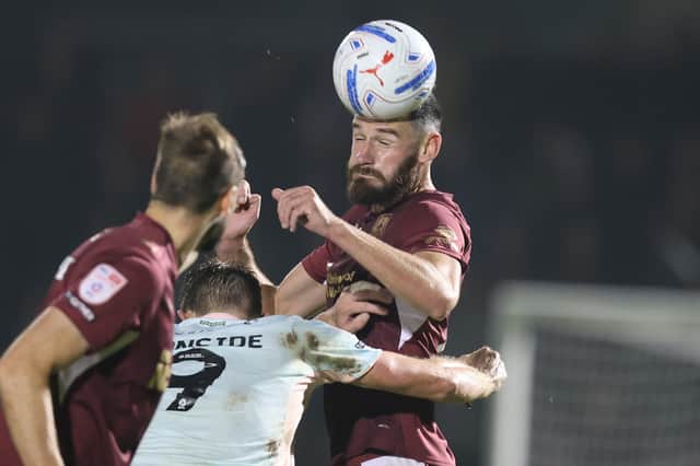 Elliott Moore wins a header