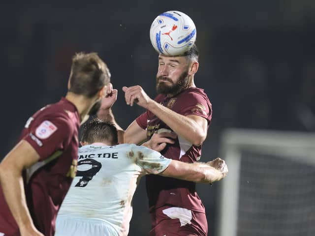 Elliott Moore wins a header
