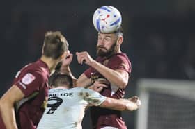 Elliott Moore wins a header