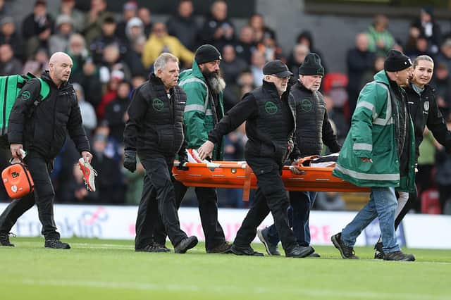 Edon Pruti is carried from the pitch on a stretcher