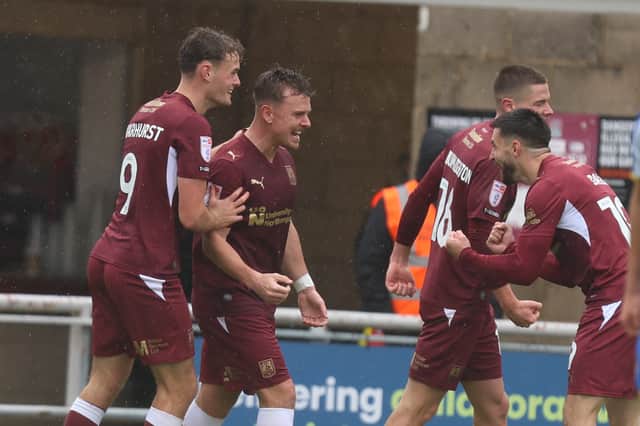 Sam Hoskins celebrates his 106th Cobblers goal