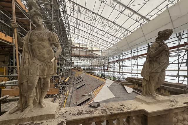 Under a covered scaffolding platform, the roof of Blenheim Palace is being renovated