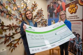 Chloe handing the cheque to Nina from Cynthia Spencer Hospice