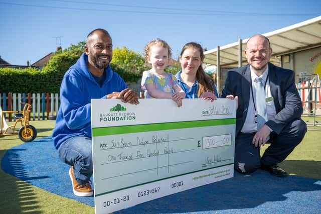 Shawn handing the cheque to Sun Beams Delapre Pre-School