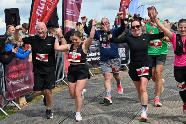 A group of runners celebrate as they approach the finish line