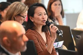 Audience members speak to researchers at The Psoriasis Association annual conference, 2025