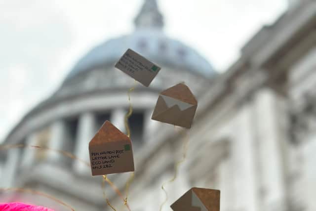 Daniella Paolozzi, Founder of Pen Written Post, wearing a custom-made headpiece crafted from handwritten letters – a creative tribute to the power of personal communication.