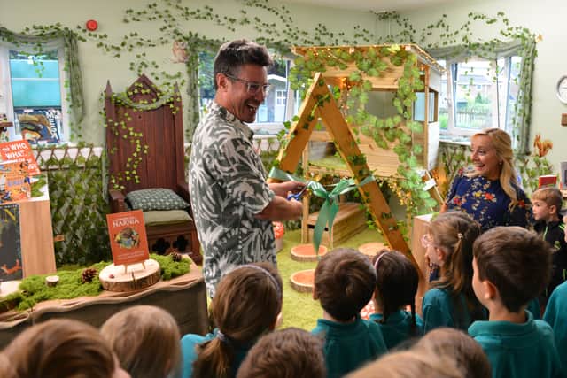 Jules Howard cut's the ribbon to officially open Naseby C of E Primary school's new 'Forest Themed' Library.