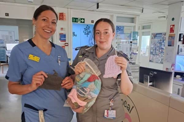 Staff from Kettering General Hospital's Neonatal Unit gratefully receive the first delivery of handmade hats and bonding square sets created by students from Tresham College's Haven Hat Collective.