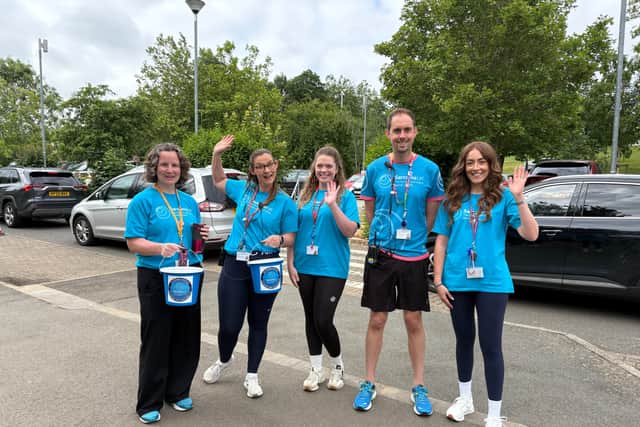 Staff collecting donations at the start of the school day.