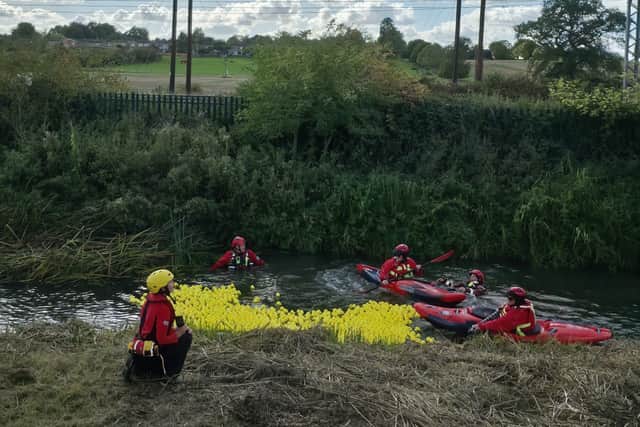 Mountain rescue herding rubber ducks at Burton Latimer Duck Race