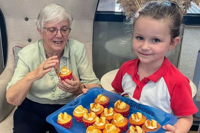 Resident Daphne being served Butterfly Cup Cakes