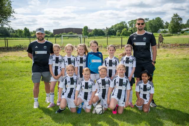 Oundle U8s team wearing their brand-new kit sponsored by David Wilson Homes