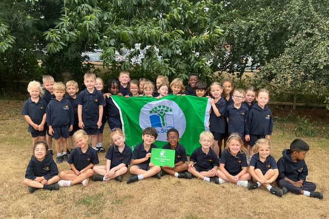 Learners of Overstone Gate Primary School's Eco Committee celebrate achieving the prestigious Eco-Schools Green Flag Award.