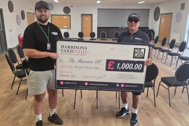 Harrison's Taxis owner Eddie Portelli presents a £1,000 donation to The Man Cave UK following the company's World Cup charity campaign.