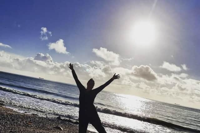 Sabine Knowles by the sea, one of her favourite places. She hopes to help more parents discover that memorable family holidays can be accessible, whether that's a UK staycation, a passport-free break to the Channel Islands, or an overseas escape.