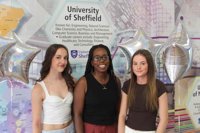 Twins Carys and Megan celebrate with Head of Sixth Form, Danielle Elliott.