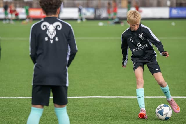 BN - SGB-12 - Players from SYL Whites U13s warming up in their sponsored kits