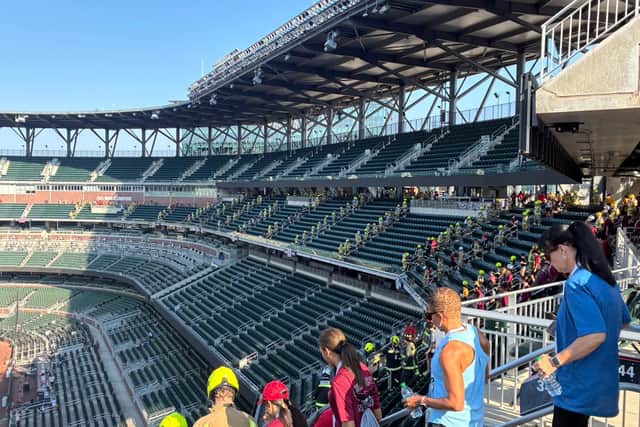 Firefighters climb through the stadium seating in honour of the 343 fallen firefighters