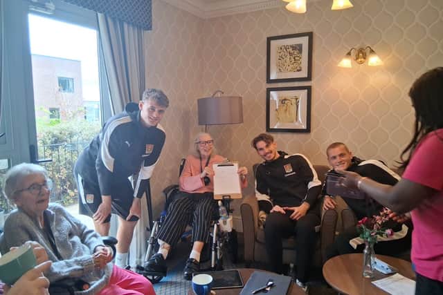 Northampton Town players James Dadge, Liam Shaw and Matty Warhurst  at Cliftonville Care Home
