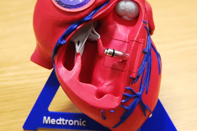 The tiny leadless pacemaker fitted inside a life-size model of a heart
