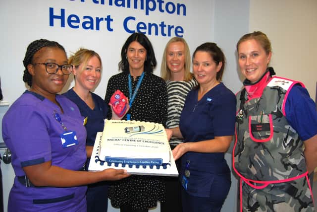 The team with a celebratory cake to mark the occasion.