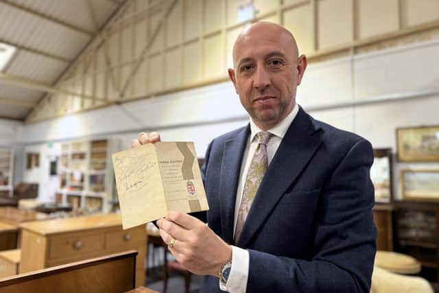 Gildings Auctioneers director Mark Gilding with Len Sumpter's menu