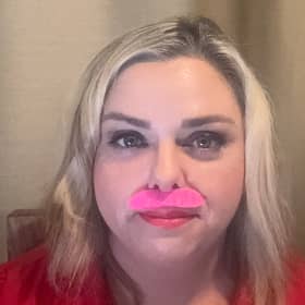 A light-hearted finish to a 21-day challenge. Northamptonshire hypnotherapist Frances B. Lafferty wears a bright pink moustache for her final video, celebrating progress rather than perfection.