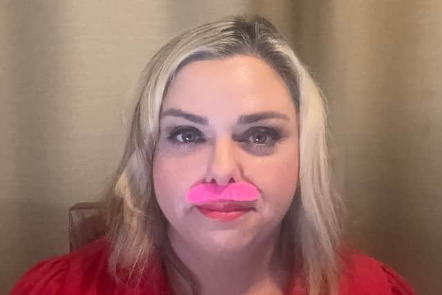 A light-hearted finish to a 21-day challenge. Northamptonshire hypnotherapist Frances B. Lafferty wears a bright pink moustache for her final video, celebrating progress rather than perfection.