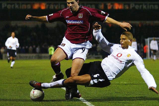 Marc Richards is tackled by Manchester United's Wes Brown during the FA Cup fourth round clash at Sixfields in January, 2004