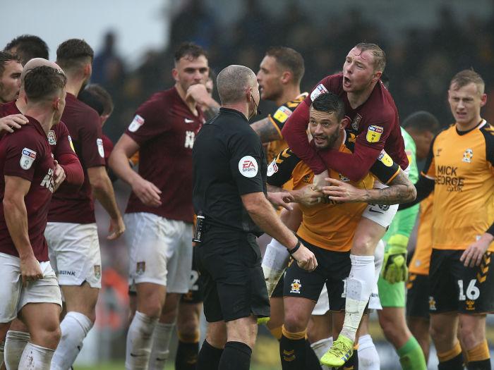 Ex-Cobbler Marc Richards gives former team-mate Nicky Adams a piggyback. Pictures: Pete Norton