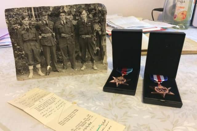 Geroge's medals along with a photograph of him and his squadron. George is pictured on the left.