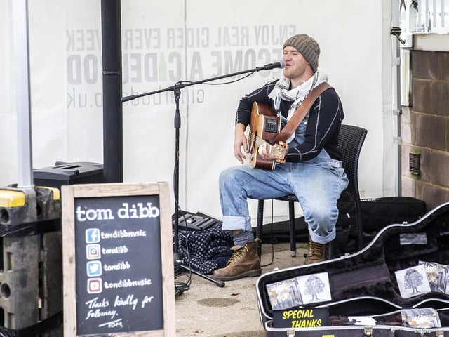 The cold weather couldn't put off customers, and they were kept in good spirits by entertainers like Tom Dibb, pictured.