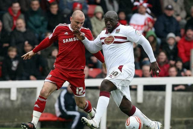Alan McCormack tussles with Adebayo Akinfenwa in a Swindon versus Cobblers clash