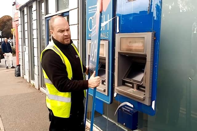 A contractor removes the ATM from the branch on closing day in October.