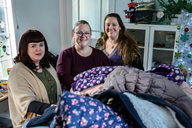 The three volunteers are helping to coordinate the huge pile of coats given to them by amazing people across the county and beyond.