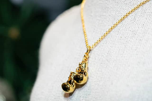 The gold pendant, designed by Steffans, is being sold with all proceeds going to Frank's charity. Pictures by Leila Coker.