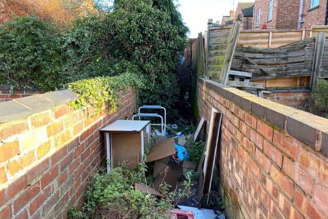 The entrance to the path filled with rubbish between Yelvertoft Road and Norton Road in Kingsthorpe, Northampton