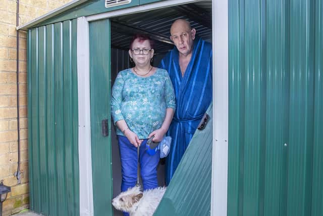 Jo and Phillip, pictured with their dog Chewwy, are asking Northampton Partnership Homes to make their garden more secure.