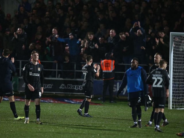 The Cobblers players acknowledge the travelling fans after the game