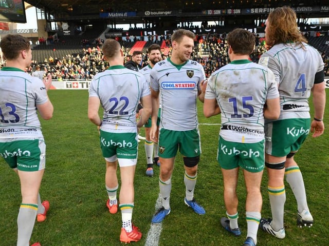 The Saints players celebrate with their travelling fans